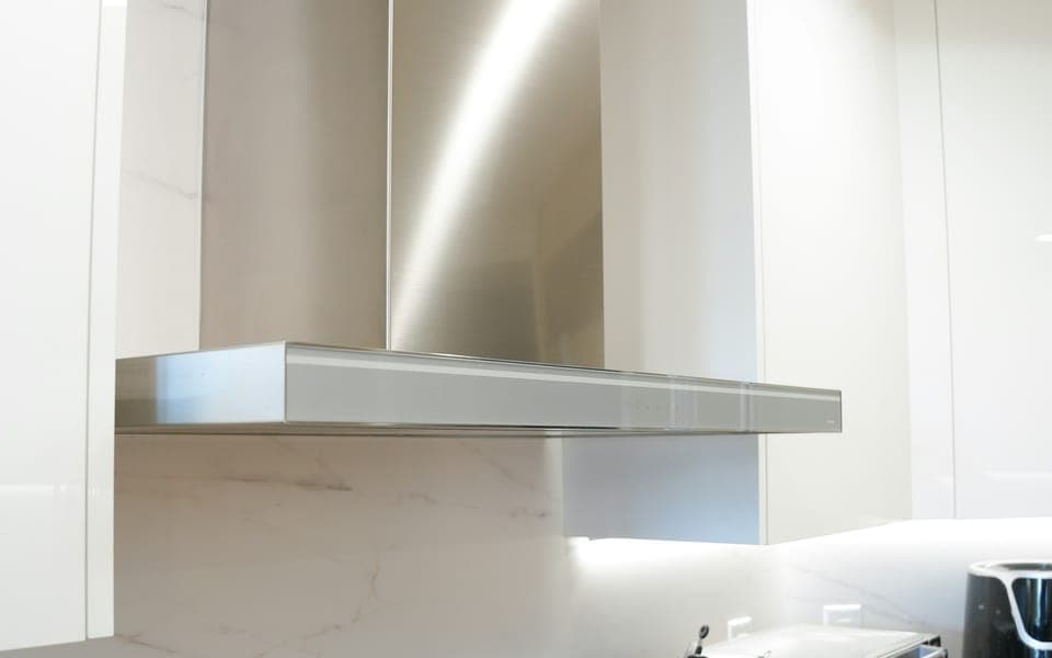 Stainless steel kitchen chimney fitted above the counter
