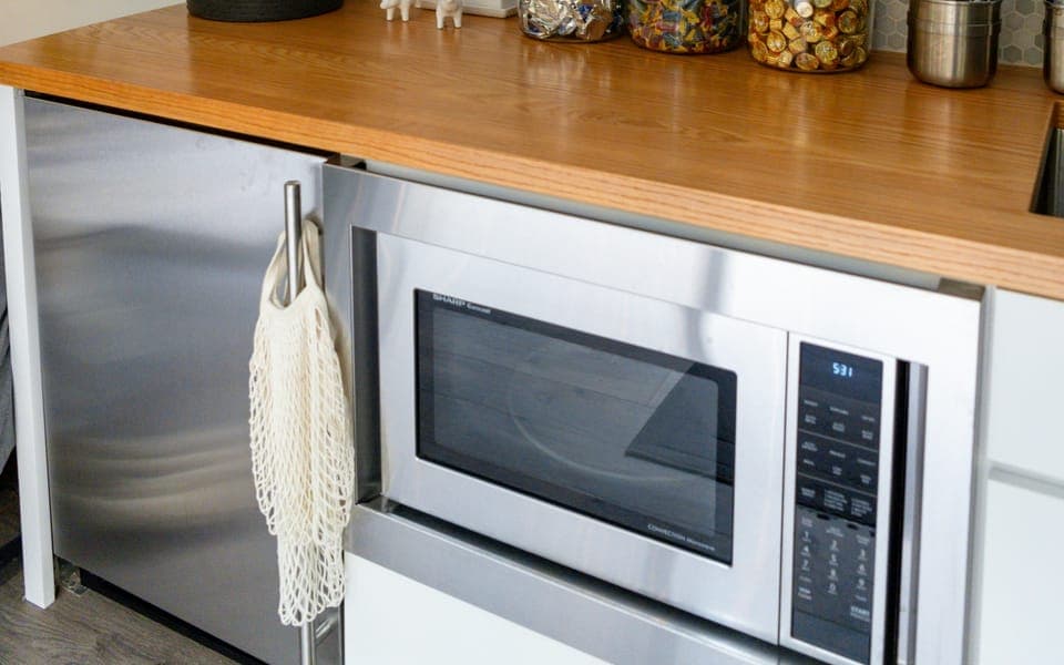 Built-in microwave under a kitchen counter